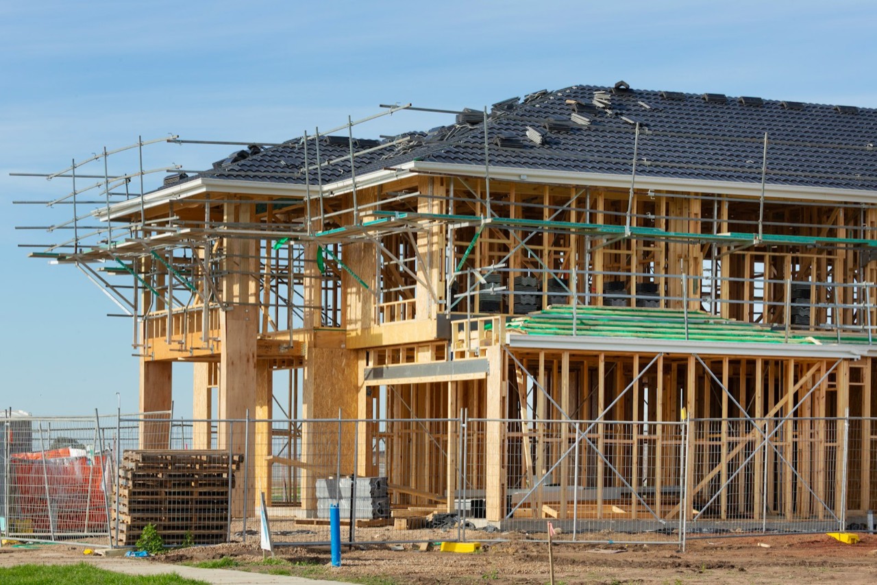 Two-story home being framed with scaffolding