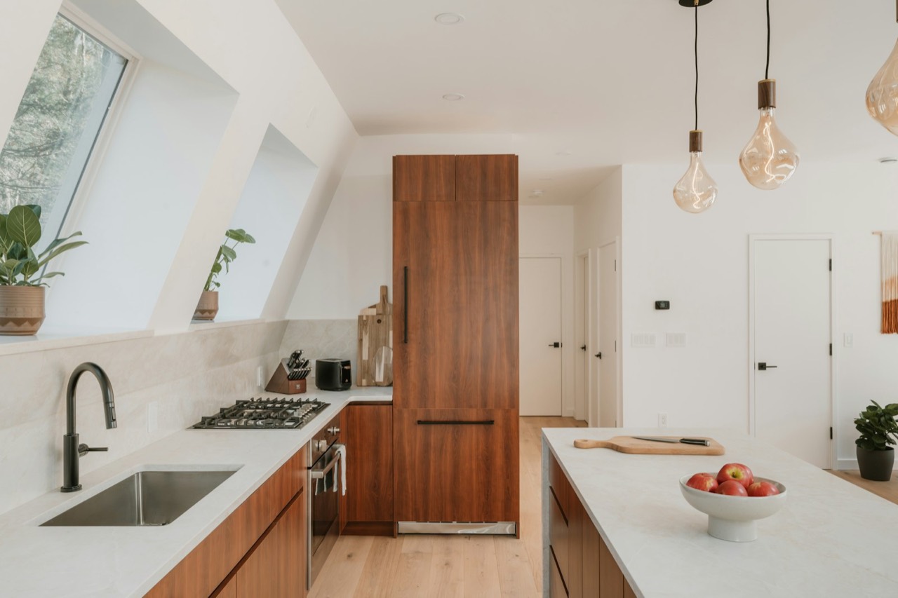 Newly remodeled kitchen with wood cabinets and stone island